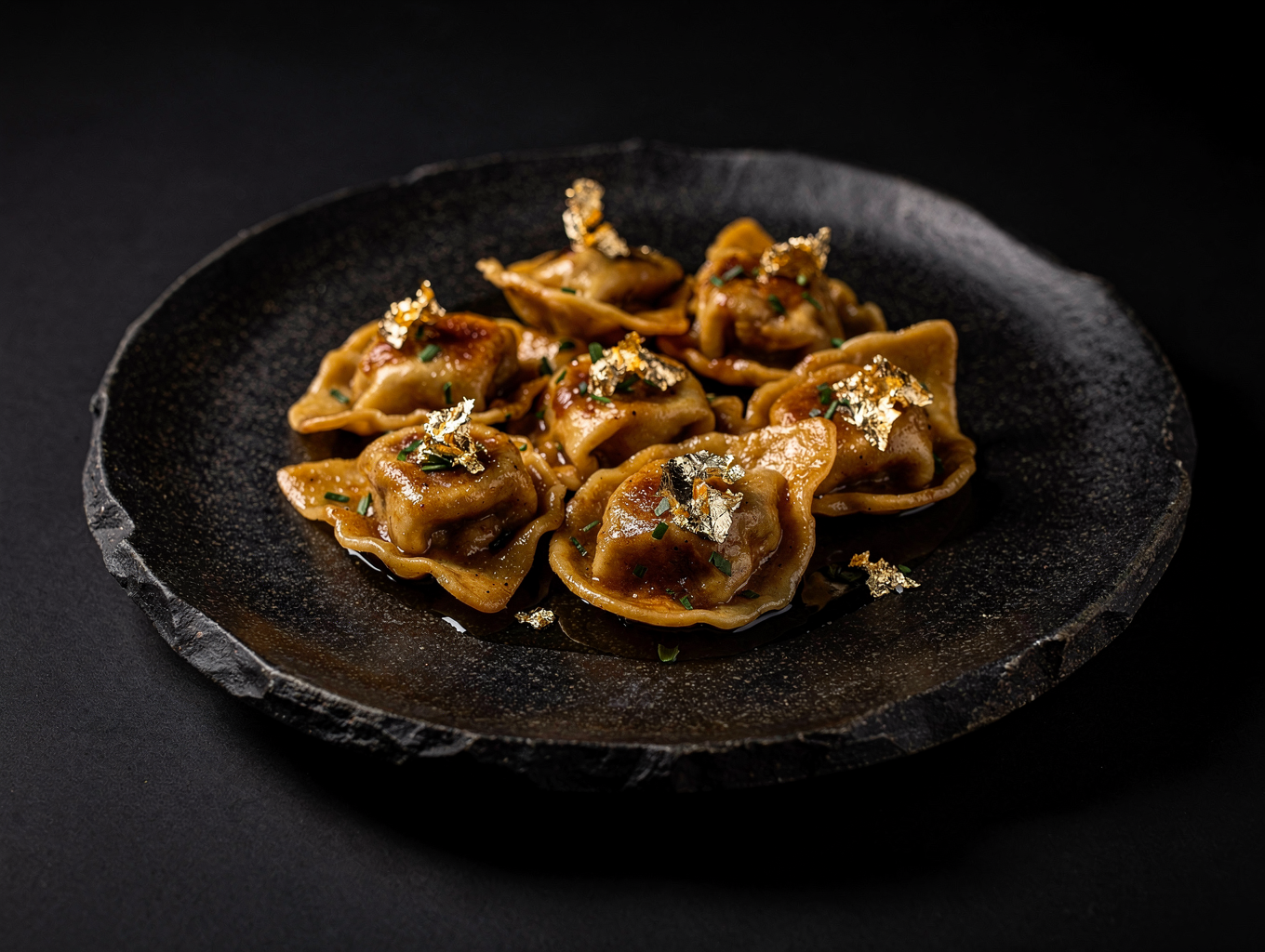 Plin style pinched ravioli in rich butter glaze
